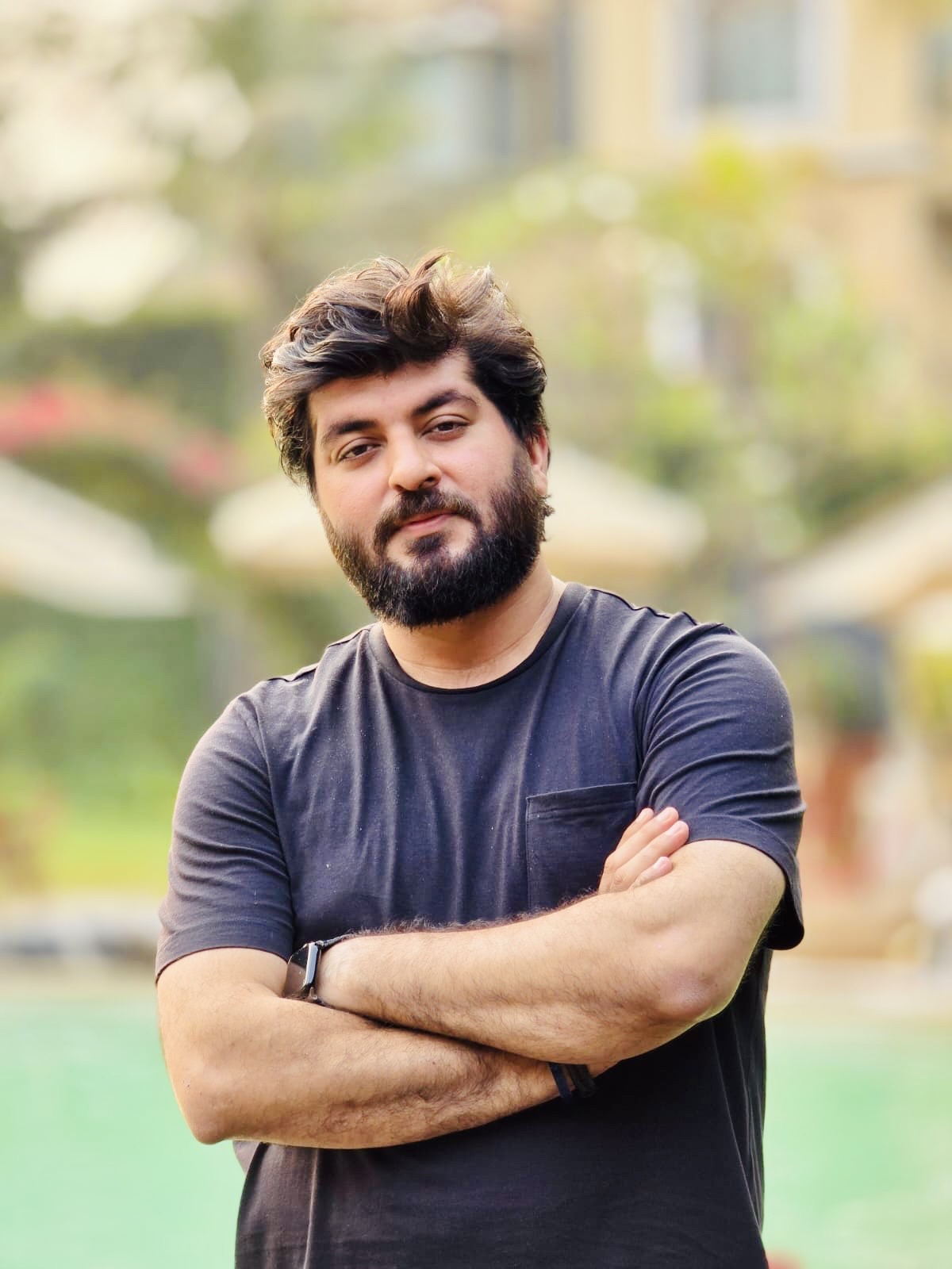 Founder of Classic24 Digital Solutions with arms crossed wearing dark t-shirt in outdoor setting